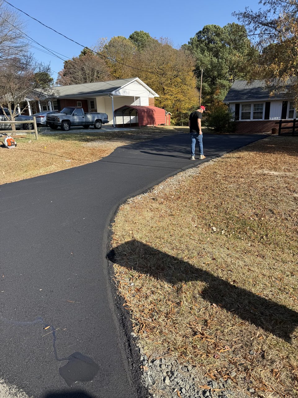 Asphalt driveway framed by NH autumn color