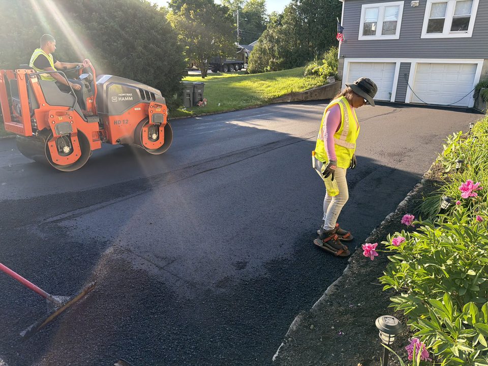 Paving crew finishing a driveway surface