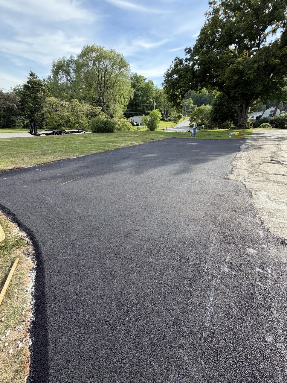 Fresh asphalt apron where the driveway meets the road